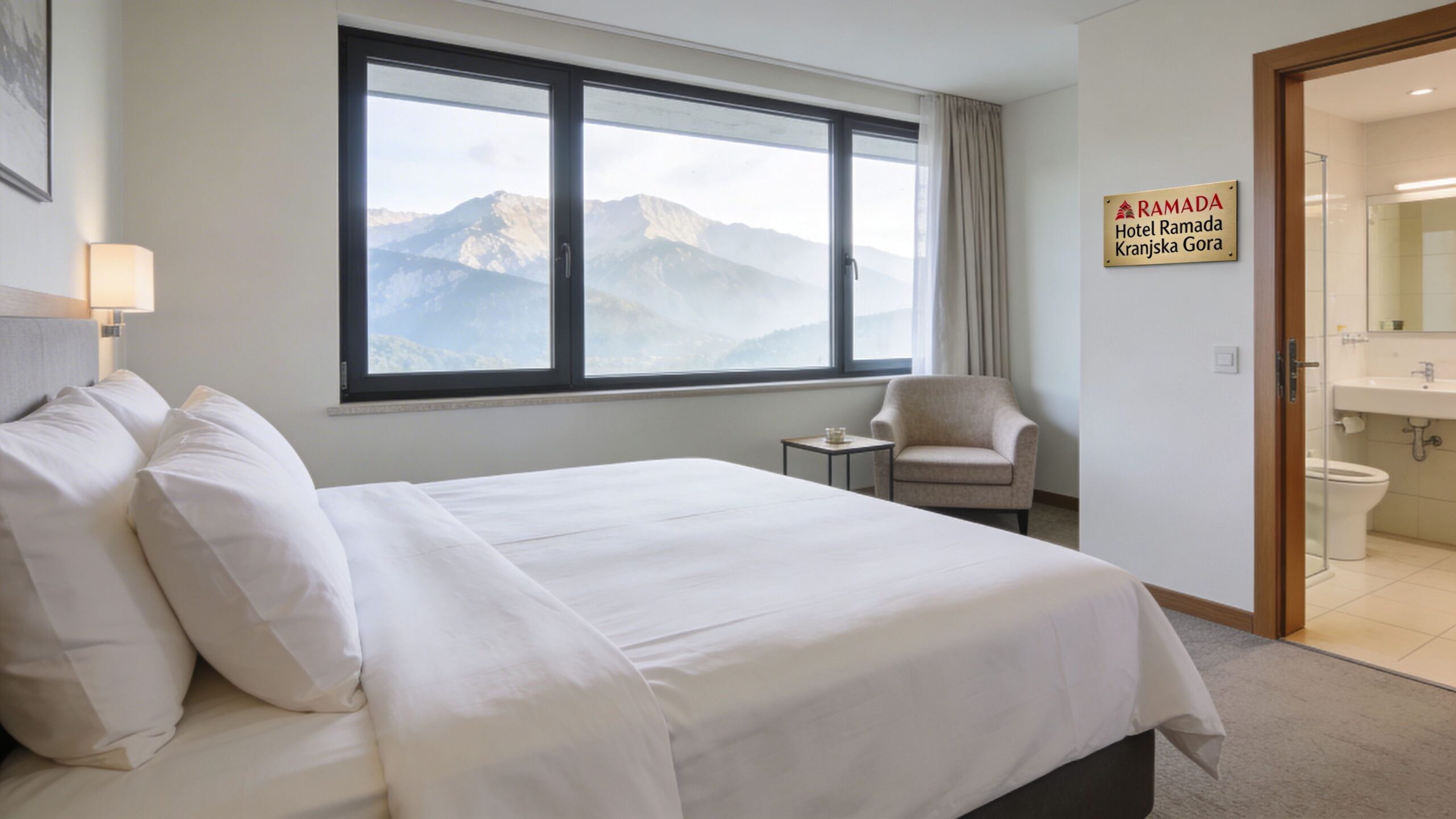 A bright hotel room featuring a comfortable double bed, a scenic mountain view, and an attached bathroom.